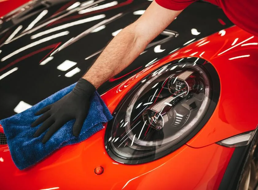 Politur der Motorhaube eines roten Autos
